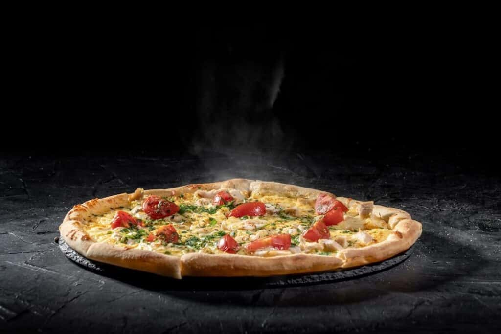 Freshly made pizza on a dark background