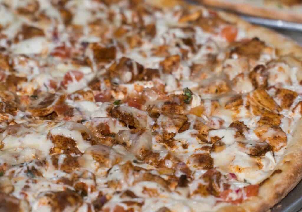 A close-up of a meat and cheese-packed pizza