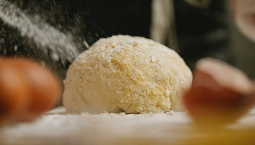 A ball of rolled dough, sprinkled with flour
