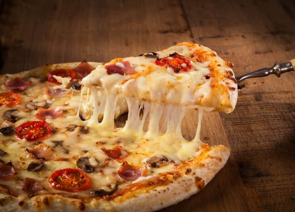 Hot pizza slice with melting cheese
