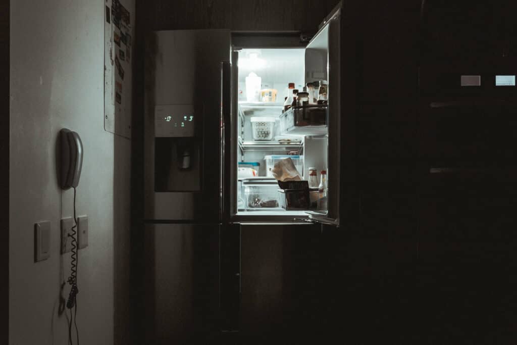 An open fridge in a dark room