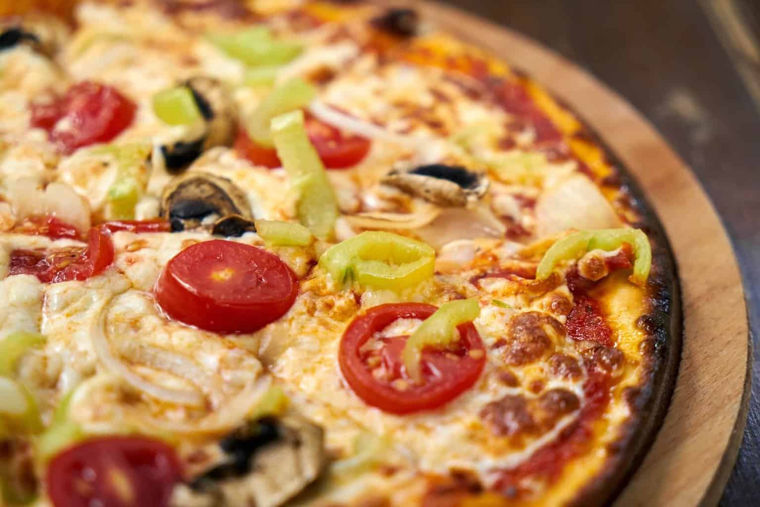 Picture of a pizza with tomatoes and peppers