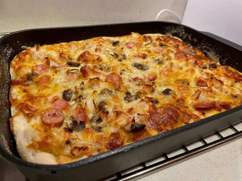 A baked deep dish pizza in a pan