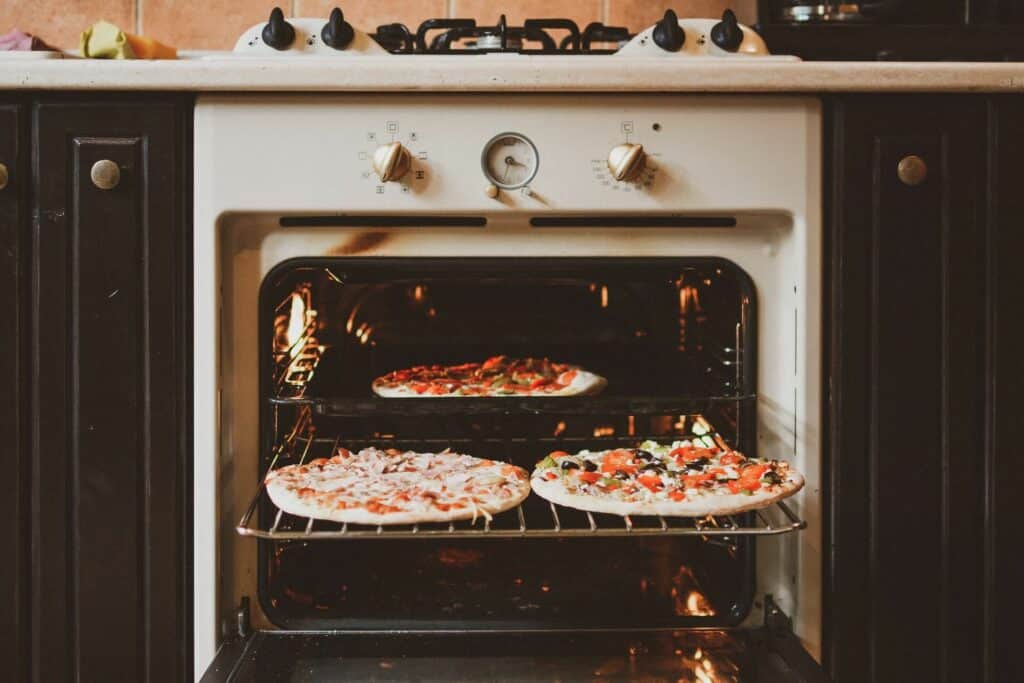Oven with pizzas on it