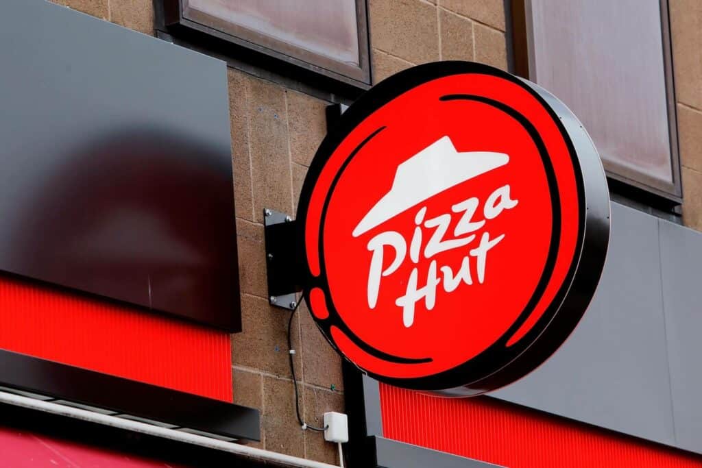 A Pizza Hut sign on the window